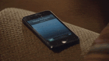 a close up of a person 's hand holding a cell phone that says mike dryden on the screen