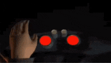 a close up of a machine with two red lights on it