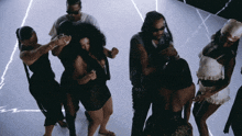 a group of people are dancing on a white floor
