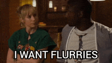 a man and a woman are sitting next to each other and the man says i want flurries