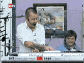 a man playing a keyboard with the number 3929 on the bottom