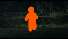 a car is driving down a road at night with a silhouette of a person flying in the air