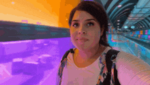 a woman is taking a selfie in a purple tunnel