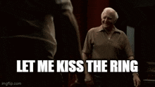 a man is standing in front of another man with the words `` how about the one in the center of my ass '' written on the screen .