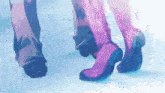 a man and a woman 's feet are shown in purple boots
