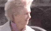 a close up of an elderly woman 's face in a blurry photo