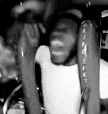 a black and white photo of a person holding a sling shot