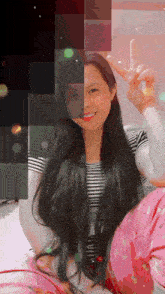 a girl with long black hair is giving a peace sign