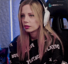 a girl wearing headphones and a playboy sweatshirt