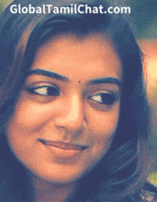 a close up of a woman 's face with the website globaltamilchat.com at the top