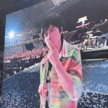 a man blowing a kiss in front of a crowd