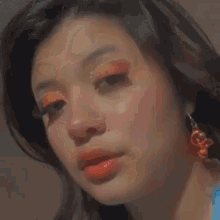 a close up of a woman 's face with red lipstick .