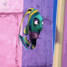 a cartoon fish is looking out of a window and making a funny face .