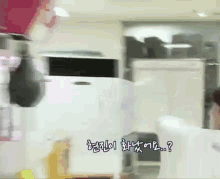 a blurry picture of a person standing in a room with korean writing on it