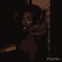 a man standing in front of a brick wall with the hashtag #thefbls on the bottom