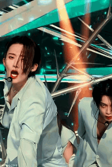 a man in a white shirt is dancing with a microphone in his hand