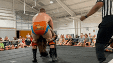 a wrestler with a kangaroo on his shorts