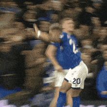 a blurry picture of a soccer player with the number 20 on their shorts