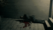 a man is laying on the ground with blood coming out of his mouth