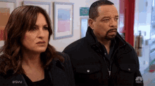 a man and a woman are standing next to each other in a hallway with the hashtag #svu on the bottom