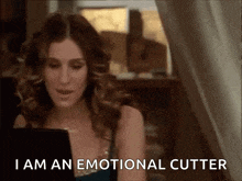 a woman is sitting in front of a laptop and saying i am an emotional cutter