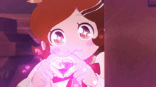 a girl is making a heart with her hands