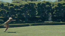 a man in a brown suit is running in a park