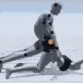 a man is kneeling down next to another man in a video game while holding a ball .