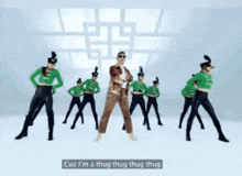 a man in a suit stands in front of a group of dancers and says " one more time "