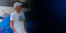 a man wearing a white t-shirt with a clock on it