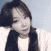 a close up of a woman 's face with long hair .