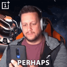 a man wearing headphones looks at a cell phone and says perhaps