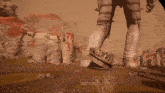 a screenshot of a video game shows a hand reaching out to touch a statue