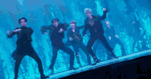 a group of men are dancing in front of a blue background and the word sugary is on the bottom