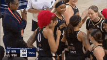 washington women 's basketball team celebrating a win in a game against at & t