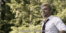 a man in a white shirt and tie is standing in front of trees and saying that is some grade a magic right there .