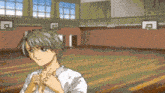 a man in a white shirt is standing in a gym