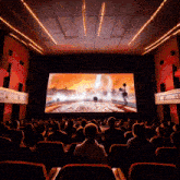 a crowd of people watching a movie in a theater with a sign that says rts on it
