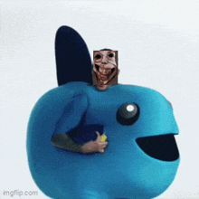 a blue stuffed animal with a face on top of it