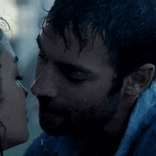 a close up of a man and a woman kissing