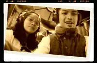 a man and a woman wearing headphones with rup100 written on the bottom