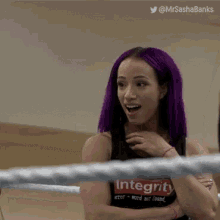 a woman with purple hair is wearing a shirt that says integrity .