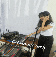 a woman standing in front of a mixer with the words chaound tech written on the bottom