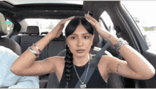 a woman is sitting in the back seat of a car