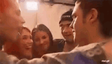 a group of people are standing around a man and a woman .