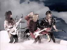 a group of men are playing guitars in front of a drum set that says ' scorpion ' on it