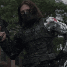 a blurred image of a man holding a gun with a pink and white background