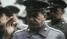 a man in a military uniform is saluting in front of a group of soldiers and the word market is on the bottom