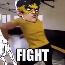 a cartoon character in a yellow shirt is standing in a gym with the word fight in front of him .