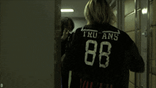 a person wearing a black shirt with the number 88